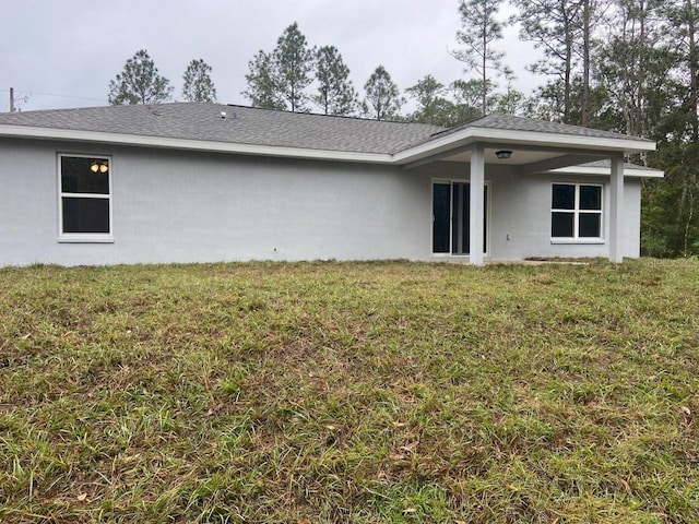 back of house with a yard