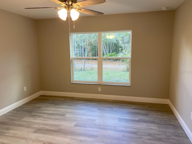 spare room with light wood-type flooring and ceiling fan