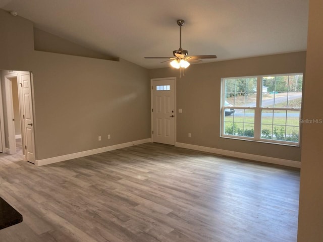 entrance foyer with light hardwood / wood-style flooring, ceiling fan, and lofted ceiling