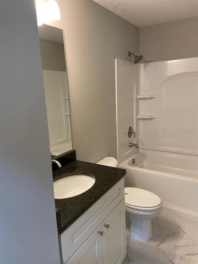 full bathroom with shower / bathing tub combination, vanity, a textured ceiling, and toilet