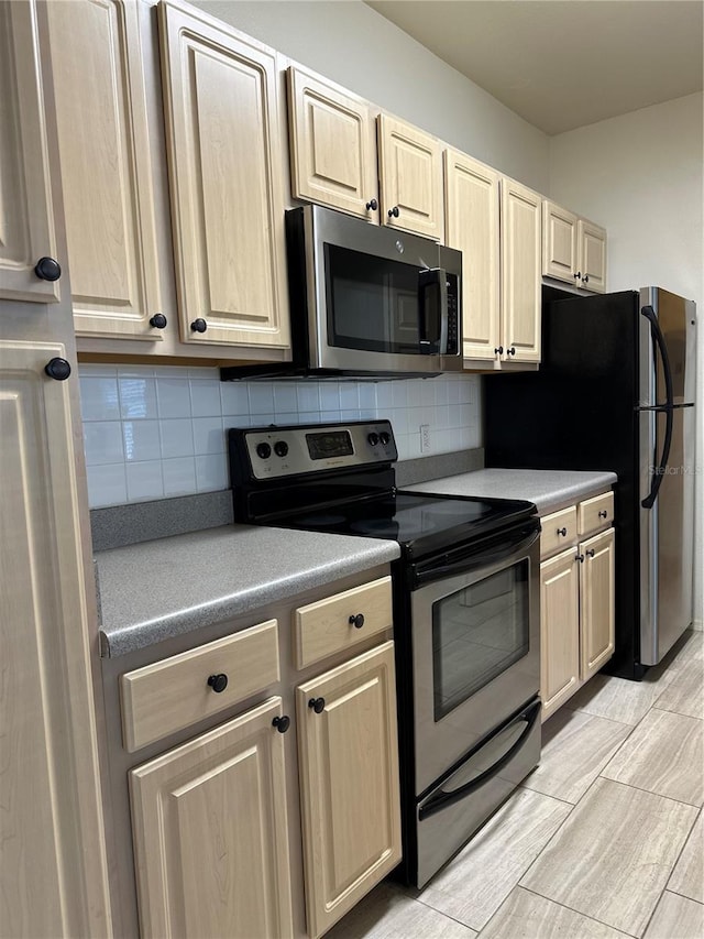 kitchen featuring appliances with stainless steel finishes and tasteful backsplash