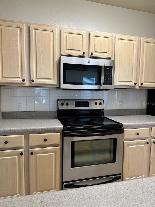 kitchen featuring backsplash, light brown cabinets, and stainless steel appliances