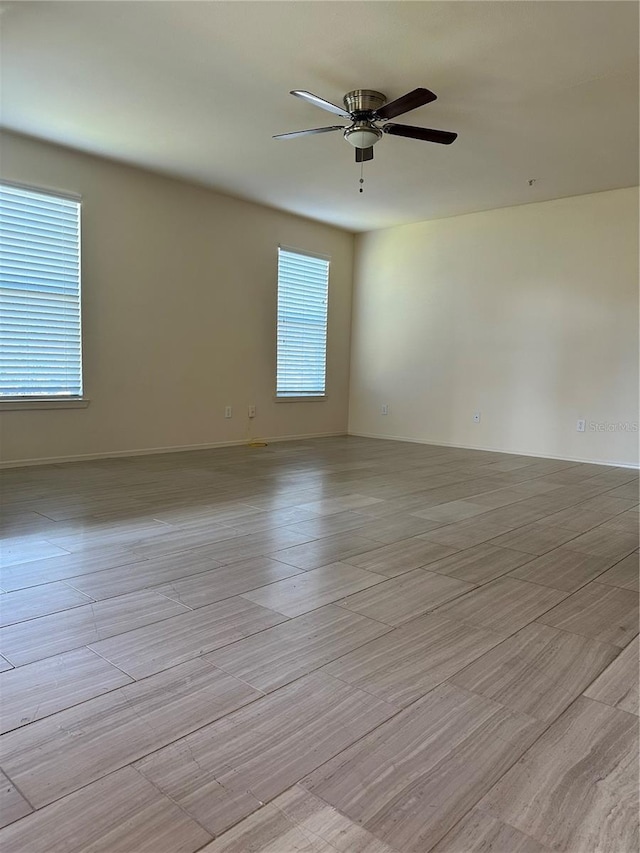 empty room featuring ceiling fan and light hardwood / wood-style floors