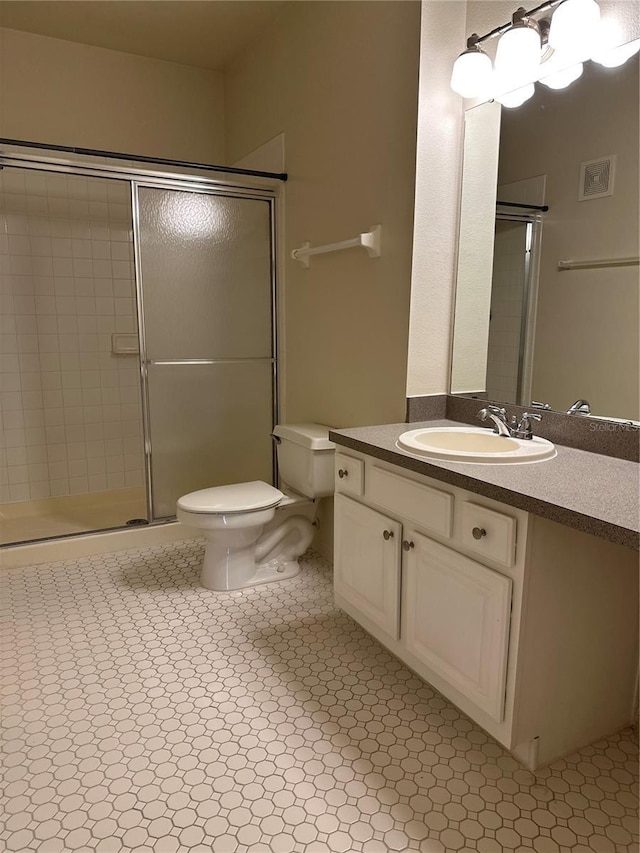 bathroom with vanity, toilet, and walk in shower