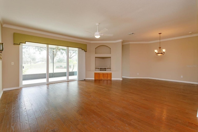 unfurnished living room with crown molding, built in features, ceiling fan with notable chandelier, and hardwood / wood-style floors