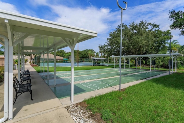 view of community featuring tennis court