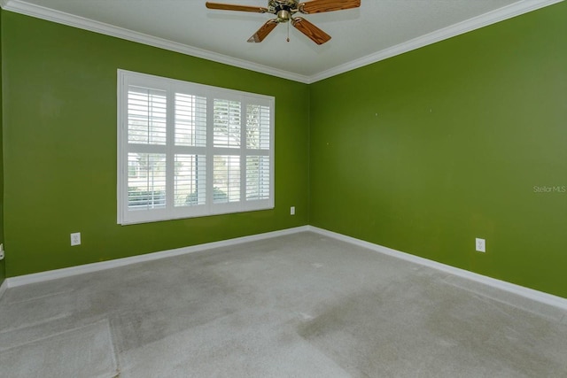 carpeted empty room featuring ceiling fan and ornamental molding