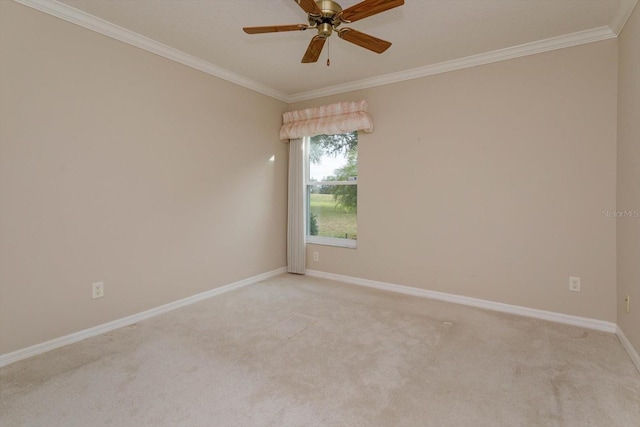 carpeted spare room featuring ceiling fan and crown molding