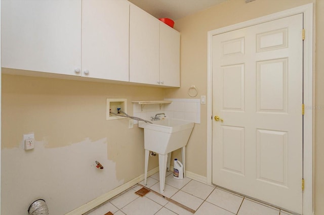 laundry room with washer hookup, cabinets, and light tile patterned flooring