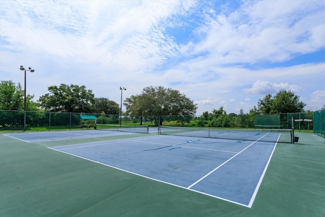 view of tennis court featuring basketball court