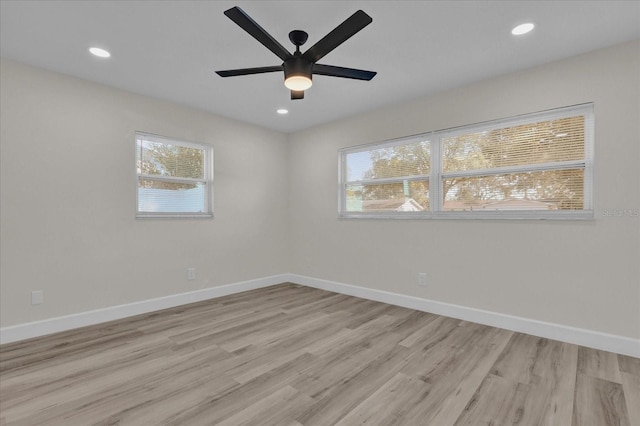 unfurnished room with light wood-type flooring and ceiling fan