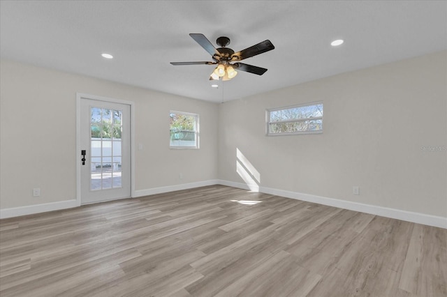 empty room featuring ceiling fan and light wood-type flooring