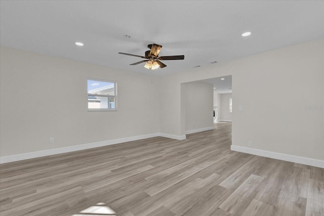 empty room featuring ceiling fan and light hardwood / wood-style flooring