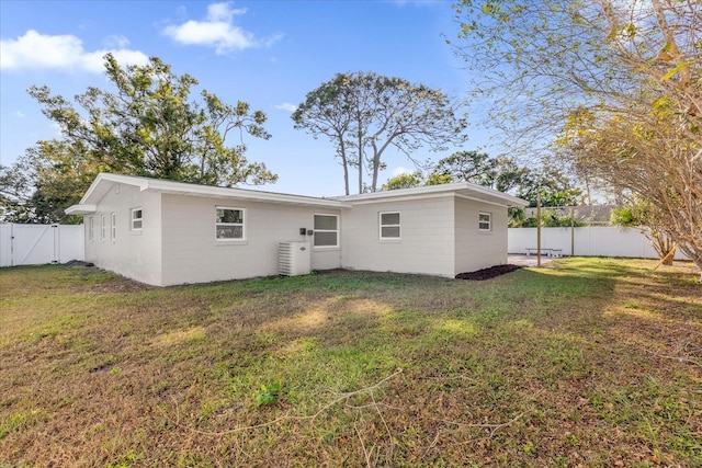 rear view of house featuring a lawn