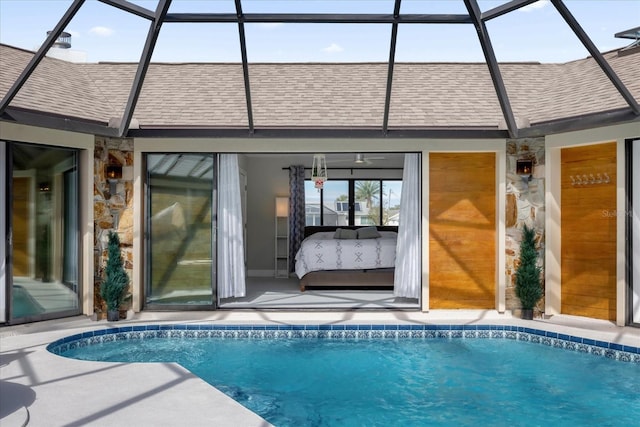 9 Crow Ct, Palm Coast, FL 32137 - rear view of property featuring roof with shingles, stone siding, and a lanai