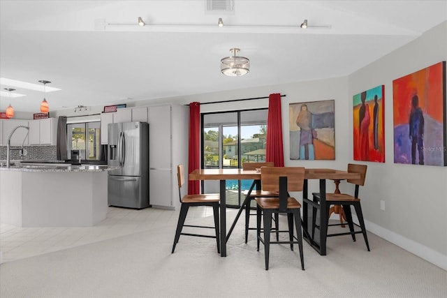 9 Crow Ct, Palm Coast, FL 32137 - dining space featuring plenty of natural light and light carpet