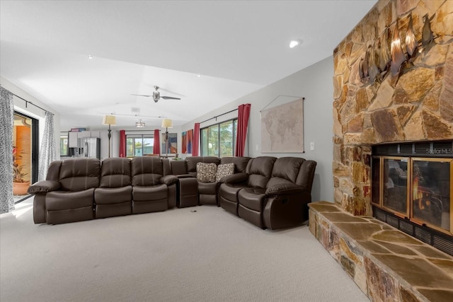 9 Crow Ct, Palm Coast, FL 32137 - carpeted living room with vaulted ceiling, a stone fireplace, and a ceiling fan