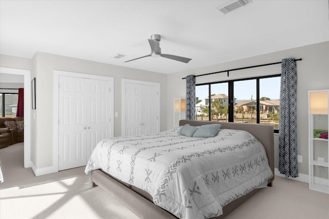 9 Crow Ct, Palm Coast, FL 32137 - bedroom with carpet floors, multiple closets, and ceiling fan