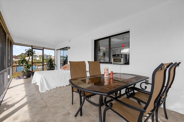 9 Crow Ct, Palm Coast, FL 32137 - dining area with light tile patterned floors, cooling unit, and expansive windows