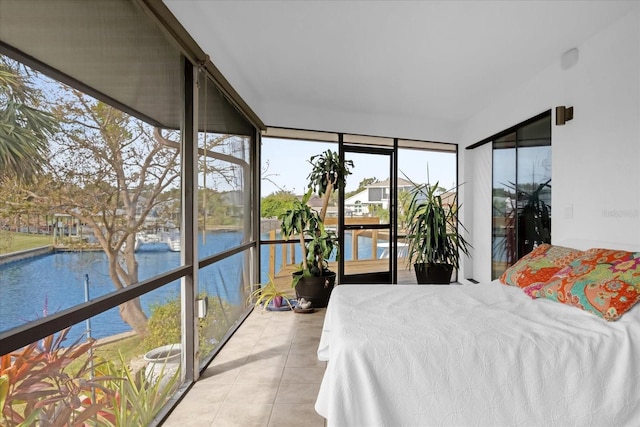 9 Crow Ct, Palm Coast, FL 32137 - bedroom with a water view, tile patterned floors, and a wall of windows