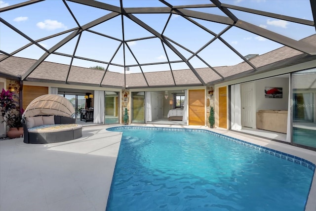 view of swimming pool featuring a patio and glass enclosure