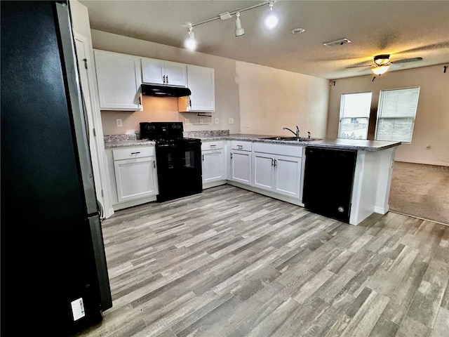 kitchen featuring black appliances, white cabinets, sink, light hardwood / wood-style flooring, and kitchen peninsula