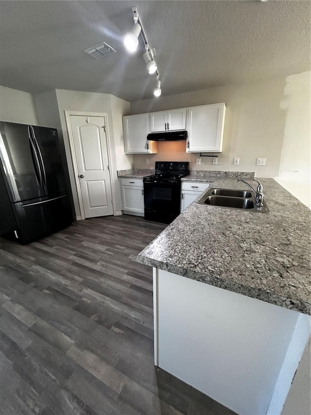 kitchen with kitchen peninsula, dark hardwood / wood-style flooring, sink, black appliances, and white cabinetry