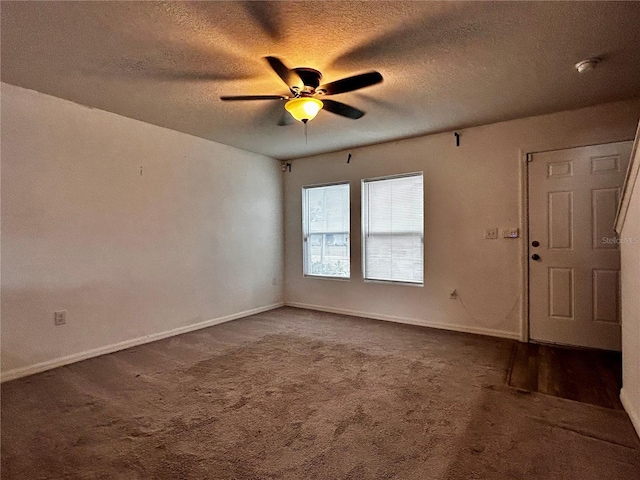 unfurnished room featuring ceiling fan, carpet floors, and a textured ceiling