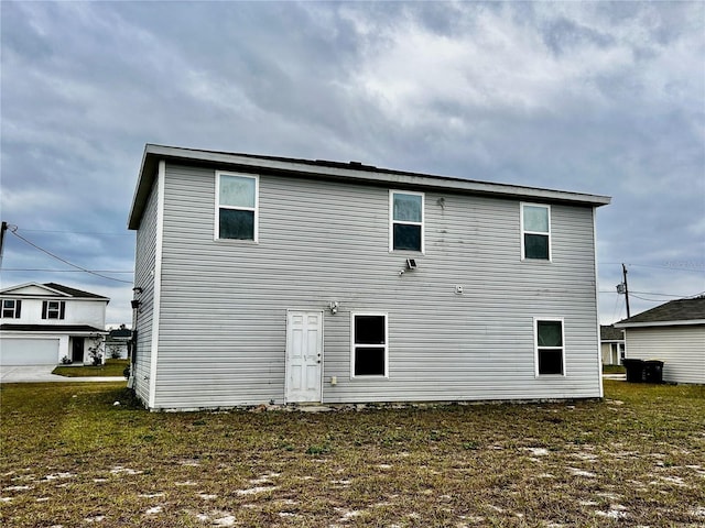 back of house with a lawn