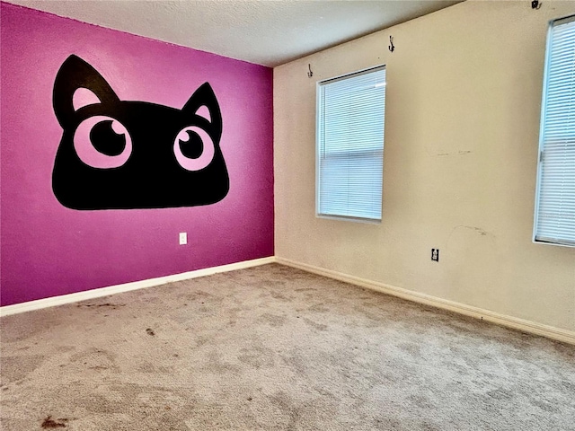 carpeted empty room with a textured ceiling