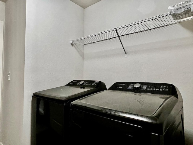 laundry room with washing machine and clothes dryer