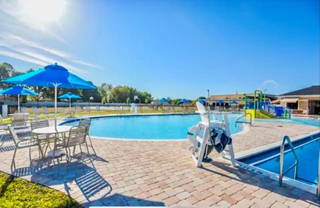 view of swimming pool featuring a patio area