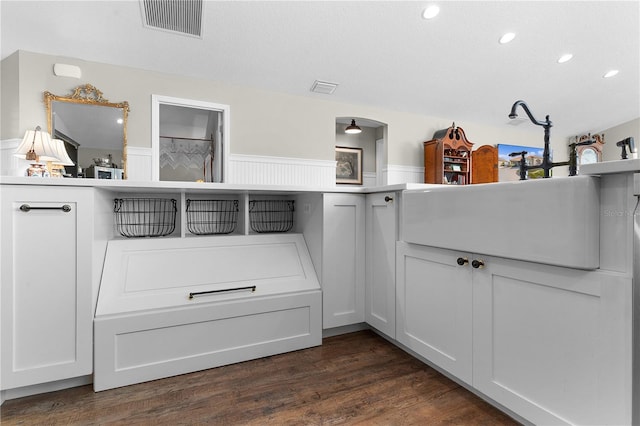 kitchen featuring white cabinets, a textured ceiling, and dark hardwood / wood-style flooring