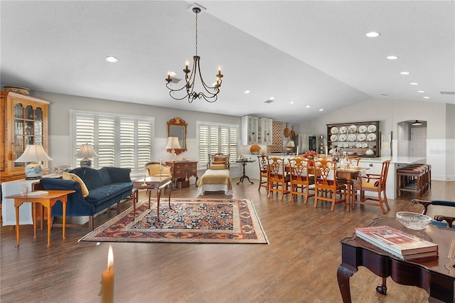 living room with dark hardwood / wood-style floors, lofted ceiling, and a wealth of natural light