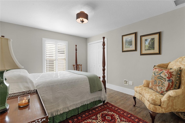 bedroom featuring hardwood / wood-style floors and a closet