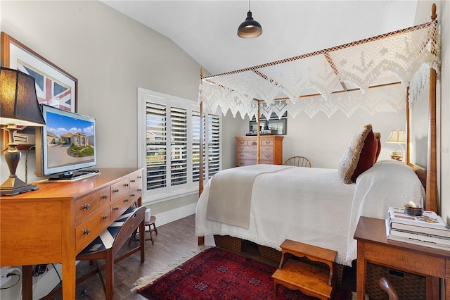 bedroom featuring hardwood / wood-style flooring and lofted ceiling