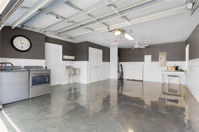 garage featuring washing machine and dryer, electric panel, a garage door opener, and ceiling fan