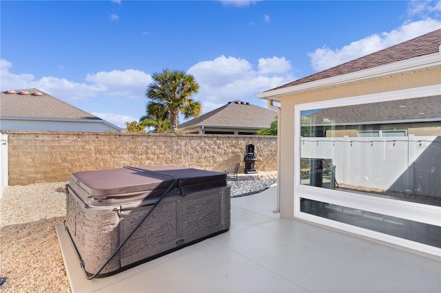 view of patio / terrace with a hot tub