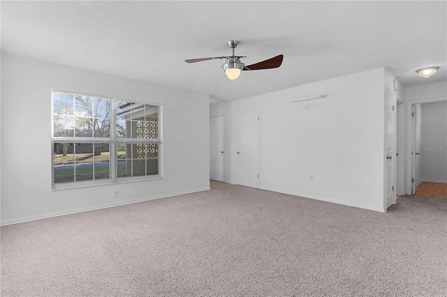 carpeted spare room with ceiling fan