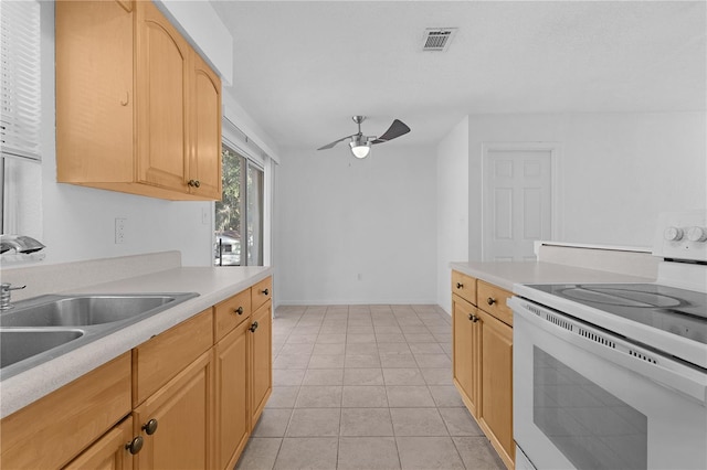 kitchen with light brown cabinetry, ceiling fan, sink, light tile patterned floors, and white electric stove