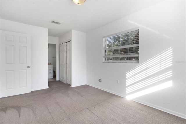 unfurnished bedroom with carpet and a closet