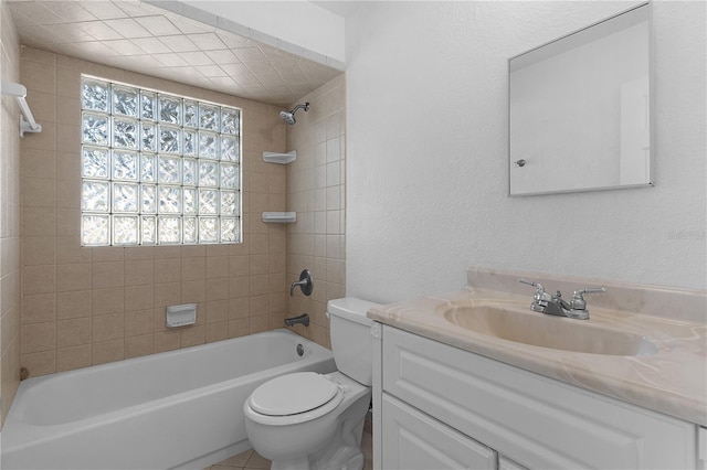 full bathroom featuring tiled shower / bath, vanity, toilet, and a wealth of natural light