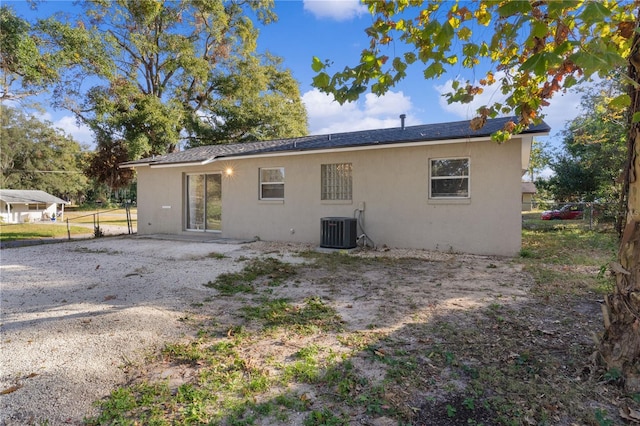 back of house featuring central AC unit