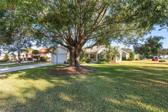 view of front of house with a garage and a front lawn