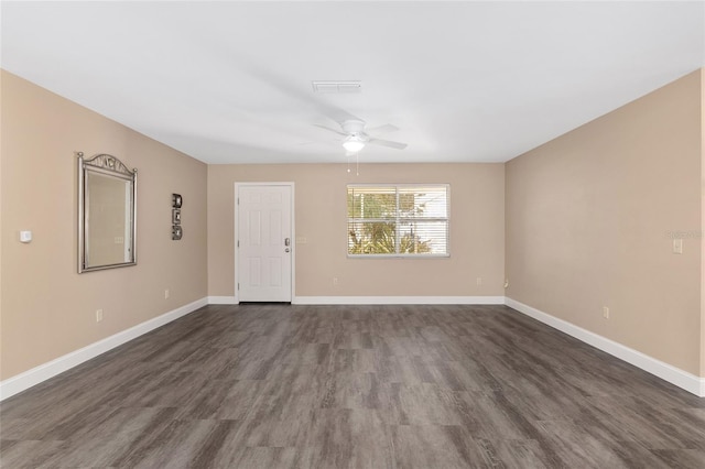 spare room featuring ceiling fan and dark wood-type flooring