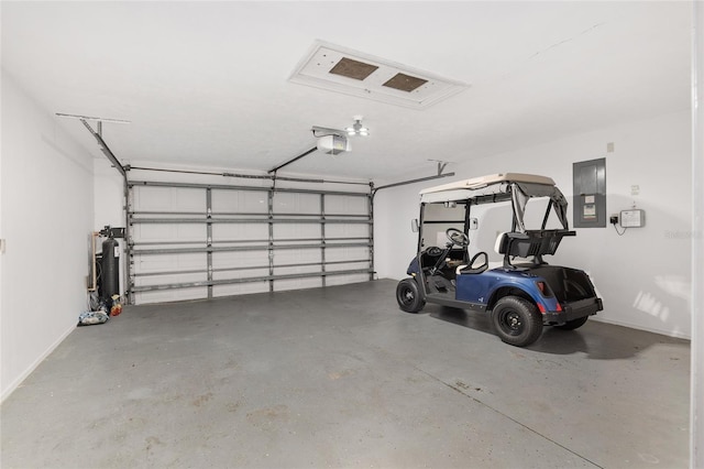 garage featuring electric panel, electric water heater, and a garage door opener