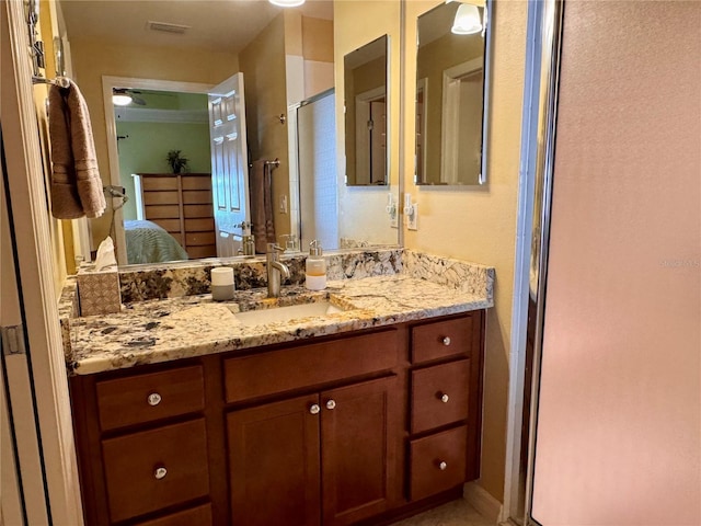 bathroom featuring vanity and an enclosed shower