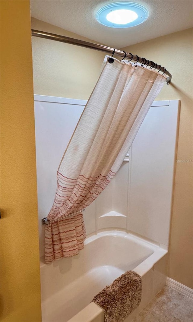 interior details featuring tub / shower combination