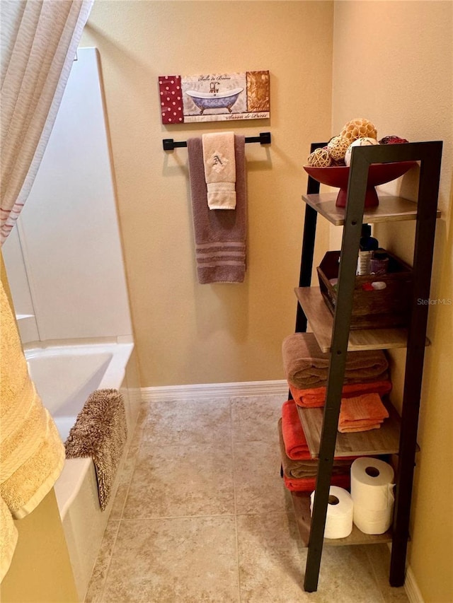 interior space featuring tile patterned floors and a washtub