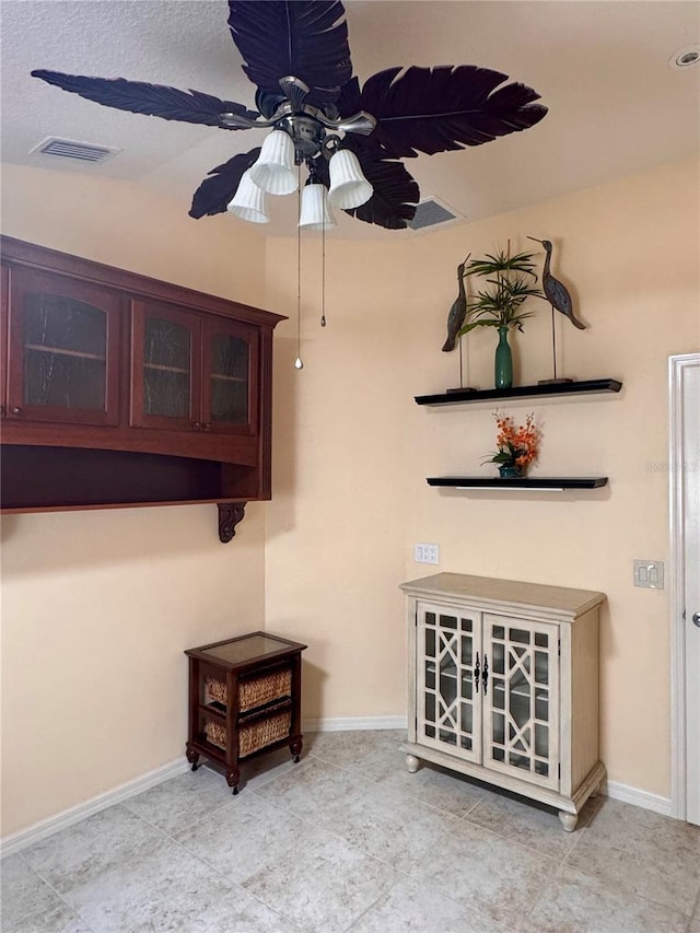 interior space with ceiling fan